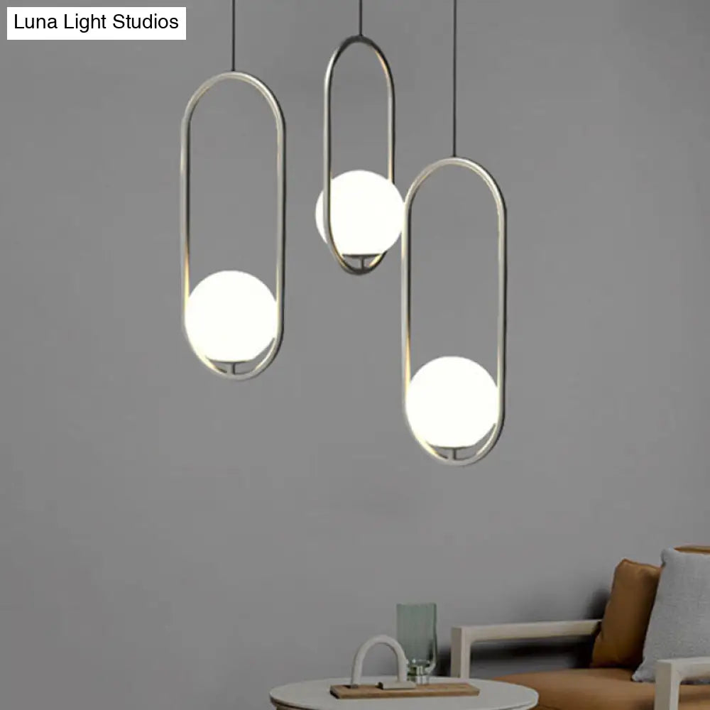 Sleek Chrome Oblong Pendant Light With Minimalist Design And Orb White Glass Shade