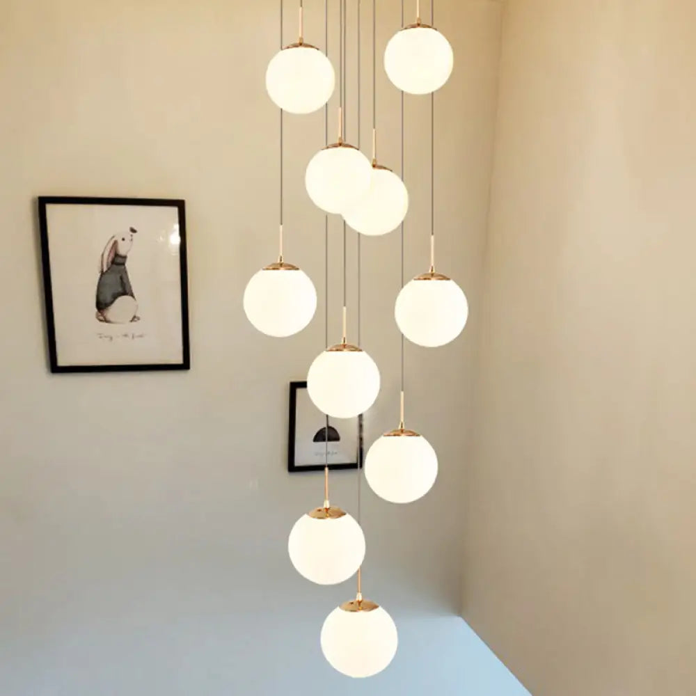 Minimalist Gold Multi-Pendant Ceiling Light With Cream Glass Bubbles And White Staircase Suspension