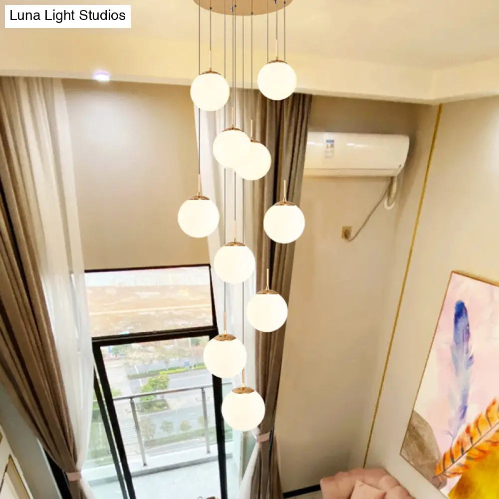 Minimalist Gold Multi-Pendant Ceiling Light With Cream Glass Bubbles And White Staircase Suspension