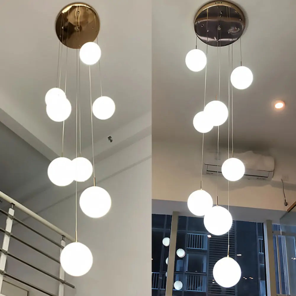 Minimalist Gold Multi-Pendant Ceiling Light With Cream Glass Bubbles And White Staircase Suspension