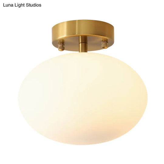 Sleek Gold Oval Semi Flush Light Fixture - Minimalist 1-Light Cream Glass Ceiling Lamp For Bedroom