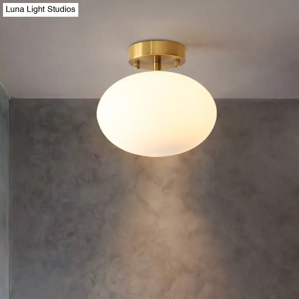 Sleek Gold Oval Semi Flush Light Fixture - Minimalist 1-Light Cream Glass Ceiling Lamp For Bedroom