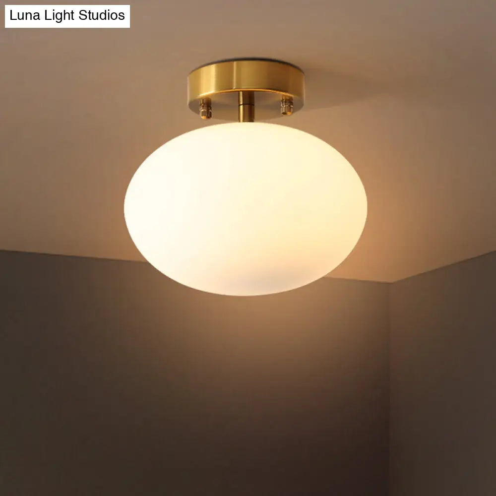 Sleek Gold Oval Semi Flush Light Fixture - Minimalist 1-Light Cream Glass Ceiling Lamp For Bedroom