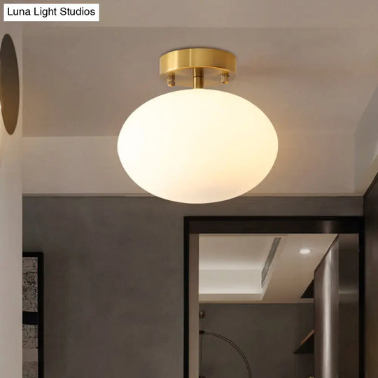 Sleek Gold Oval Semi Flush Light Fixture - Minimalist 1-Light Cream Glass Ceiling Lamp For Bedroom