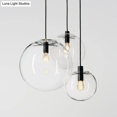 Minimalistic 1-Light Black Pendant Light Fixture - Clear Glass Globe Design For Restaurants