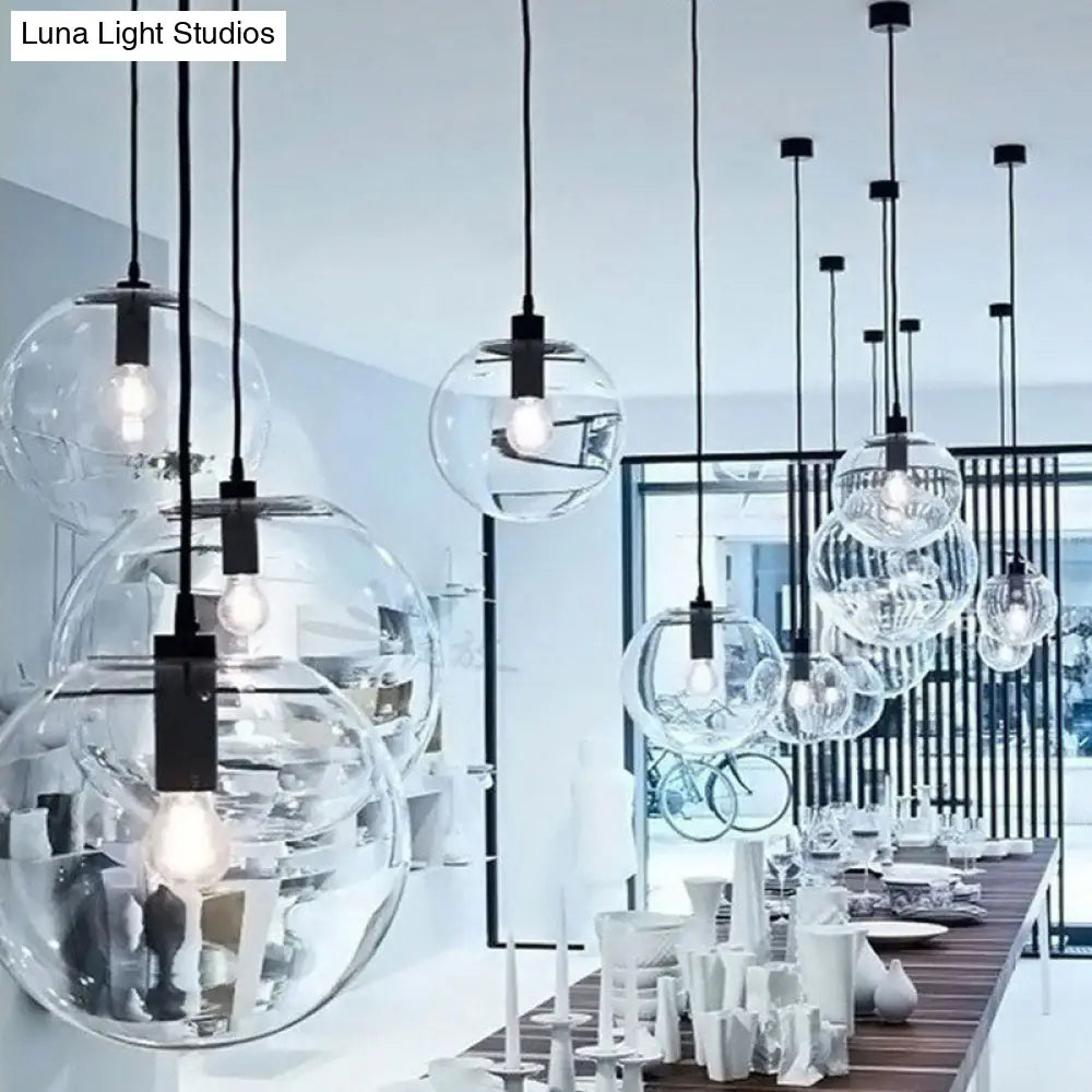 Minimalistic 1-Light Black Pendant Light Fixture - Clear Glass Globe Design For Restaurants