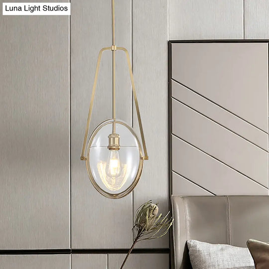 Modern Brass Pendant Light With Clear Glass Shade And Unique Halberd Frame