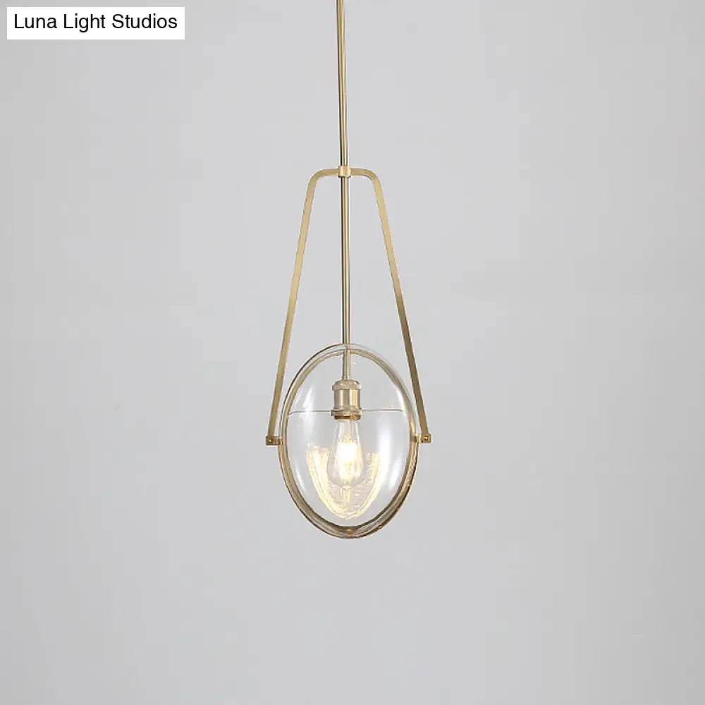 Modern Brass Pendant Light With Clear Glass Shade And Unique Halberd Frame