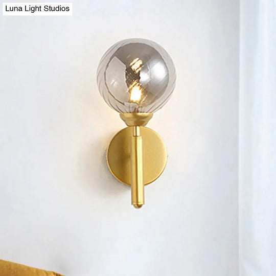 Modern Brass Wall Light With Smoked Textured Glass Globe Bulb