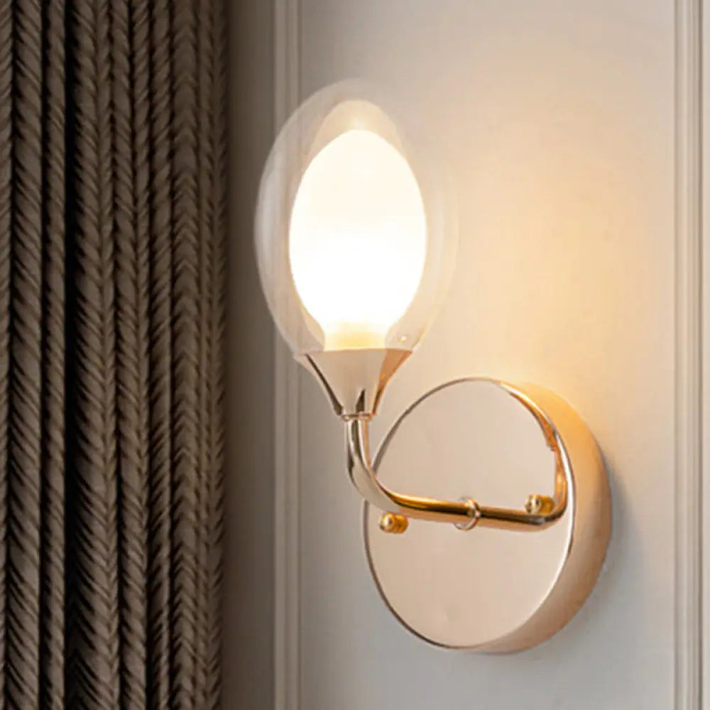 Modern Brass Wall Sconce With Clear Glass Shade - Oval Design For Dining Room