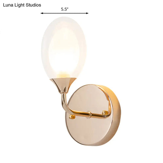 Modern Brass Wall Sconce With Clear Glass Shade - Oval Design For Dining Room