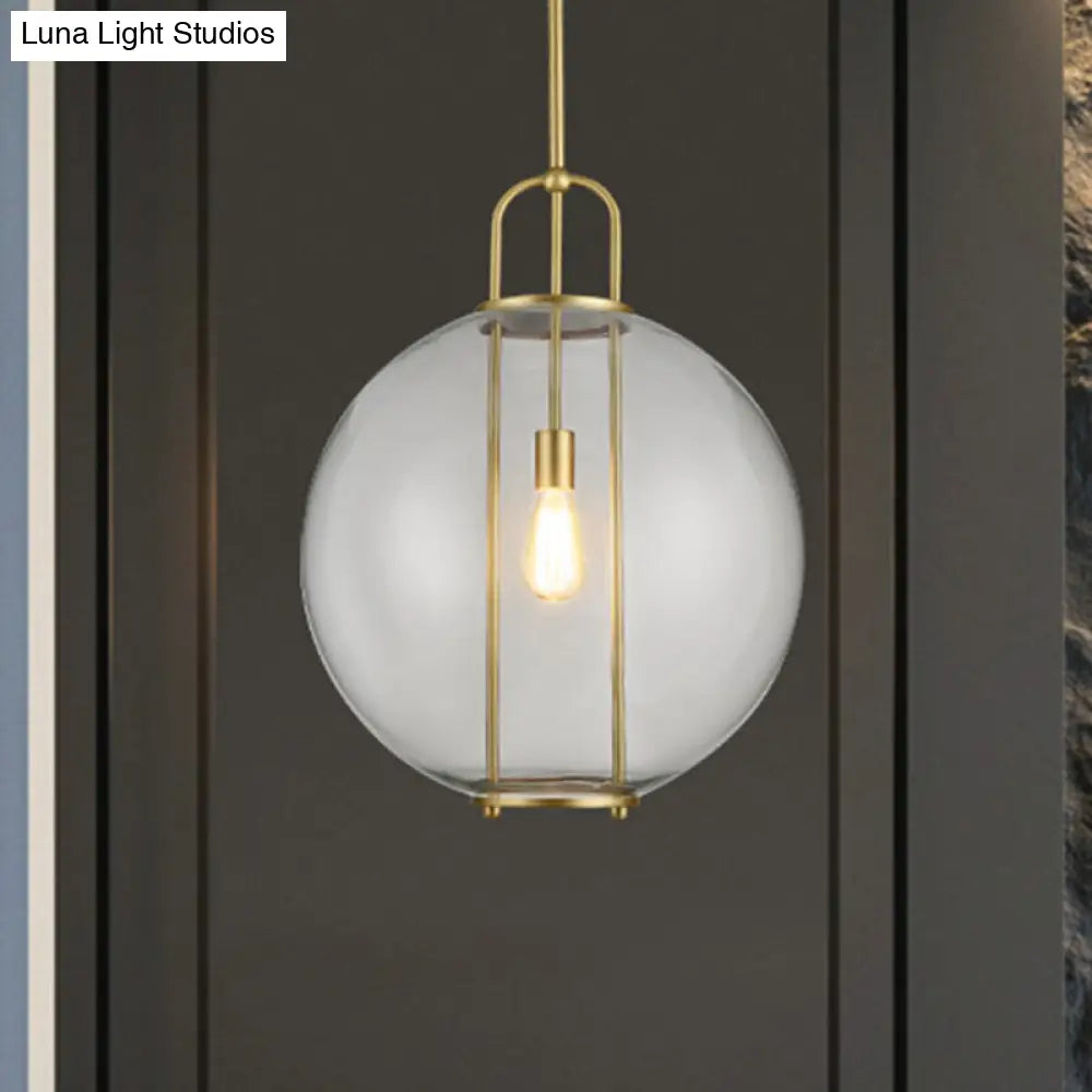 Clear Glass Hanging Lamp With Postmodern Globe Design - 1-Light Pendant In Brass For Bedside