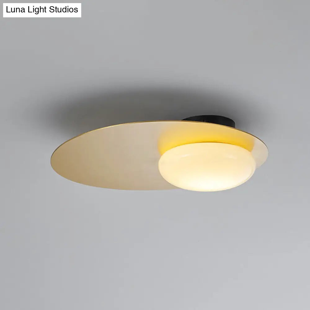 Modern Cream Glass Flush Mount Lamp: Designer 1-Light Ceiling Fixture With Black/Brass Disk Top
