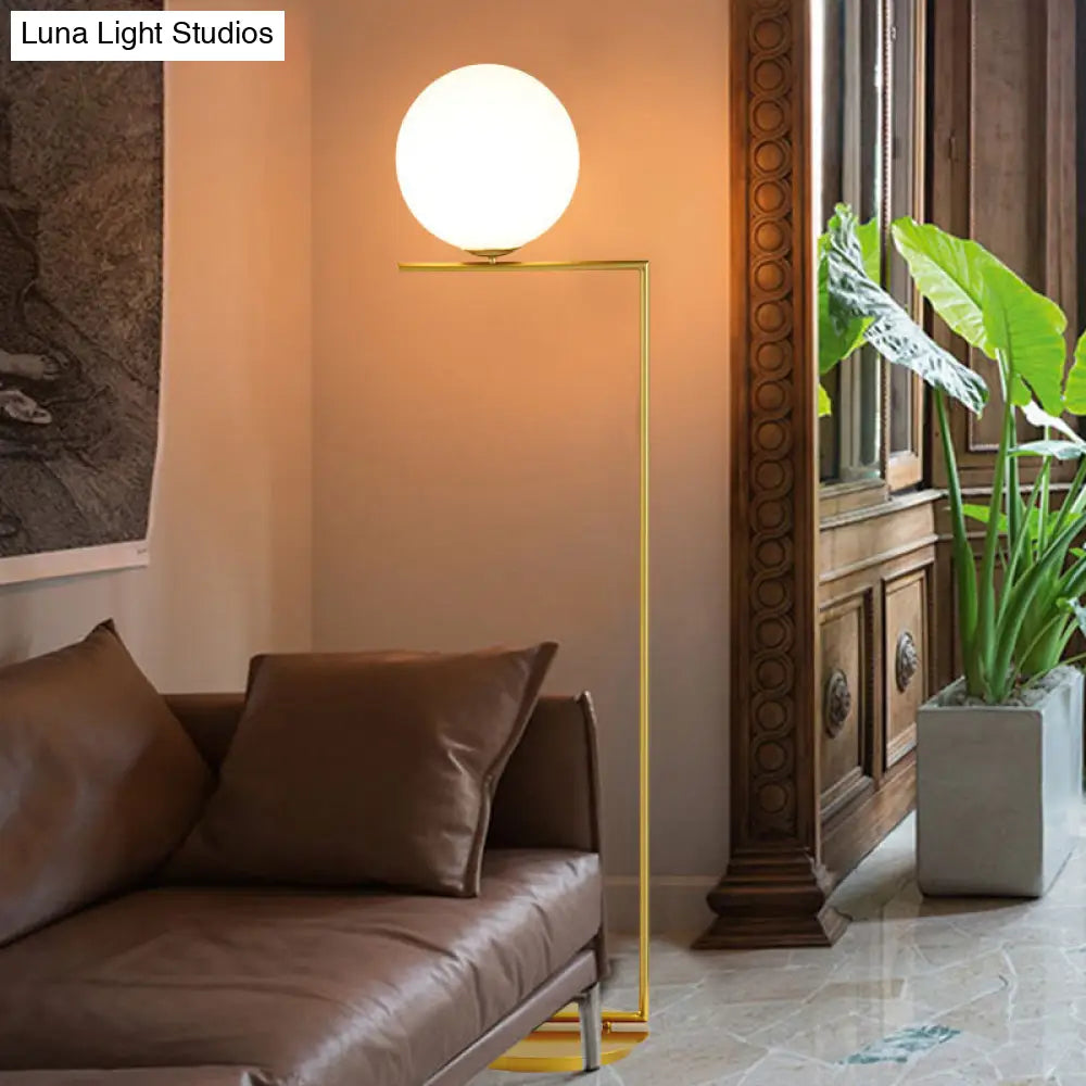 Modern Frosted Glass Spherical Floor Lamp With Gold Finish And Right Angle Arm