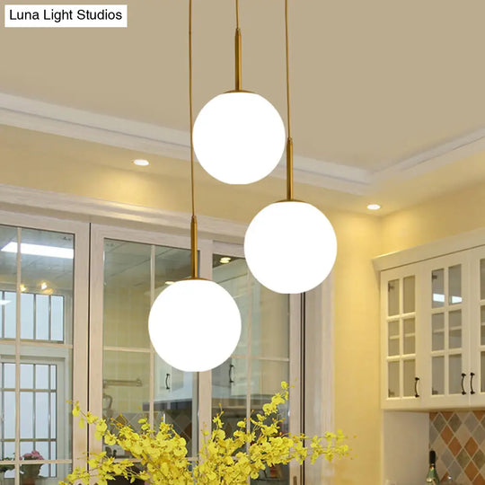 Modern White Glass Orb Hanging Ceiling Light With 3 Lights And Brass Finish