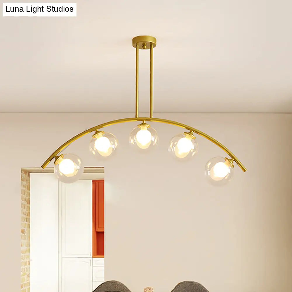 Modern Glass Orb Island Pendant Light With Brass Arch Arm - 5 Bulbs White/Clear Design For Dining