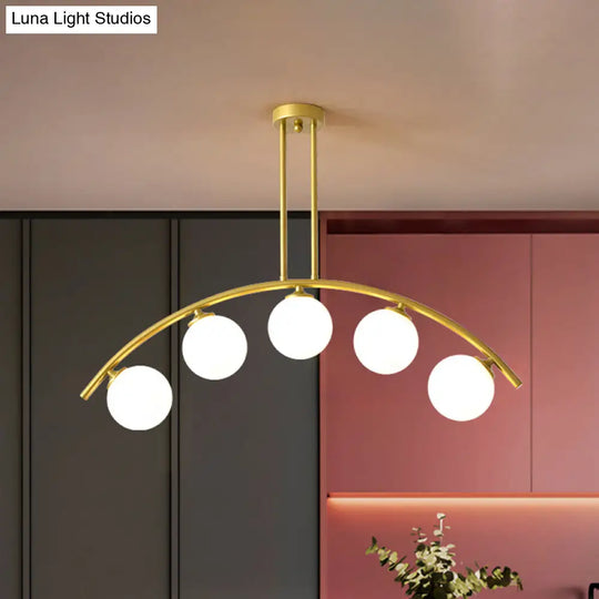 Modern Glass Orb Island Pendant Light With Brass Arch Arm - 5 Bulbs White/Clear Design For Dining