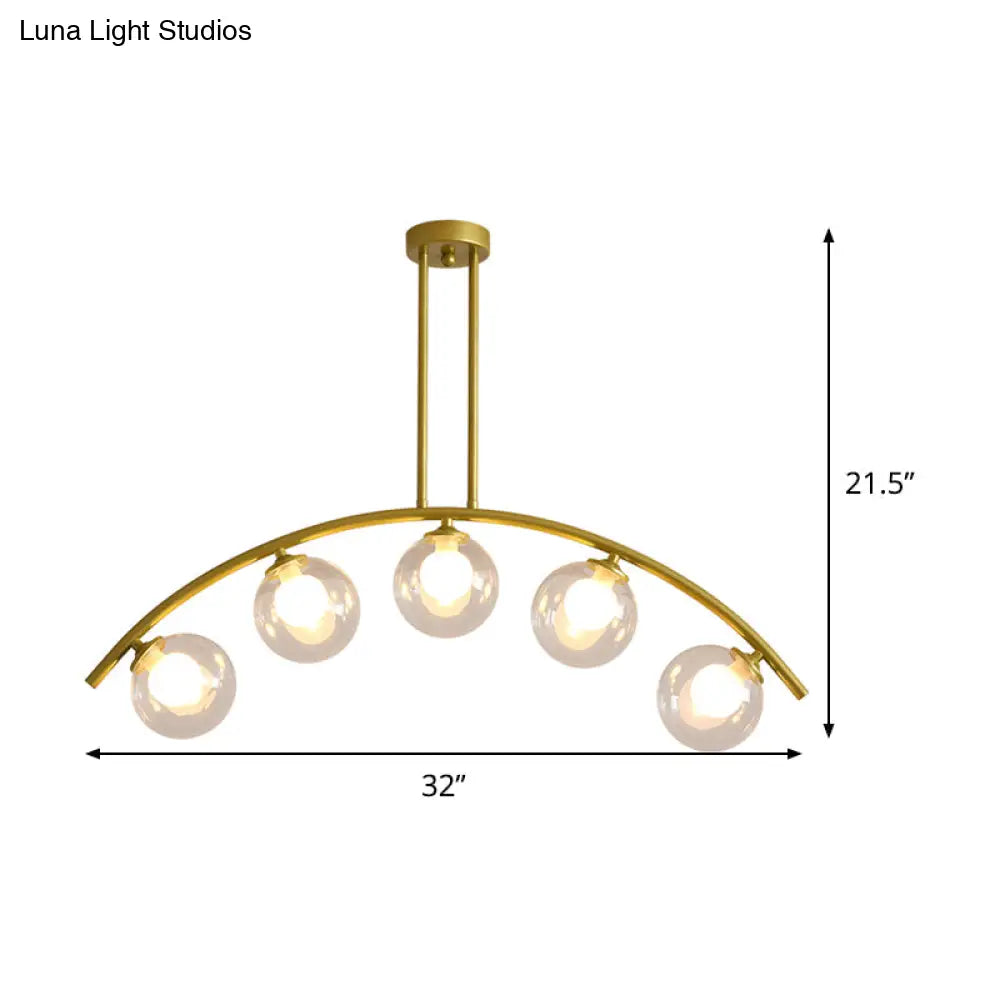 Modern Glass Orb Island Pendant Light With Brass Arch Arm - 5 Bulbs White/Clear Design For Dining