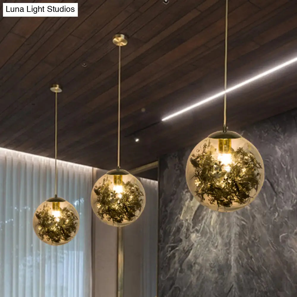 Modern Globe Pendant Light With Clear Glass And Inner Leaf Design In Silver/Gold For Bedroom