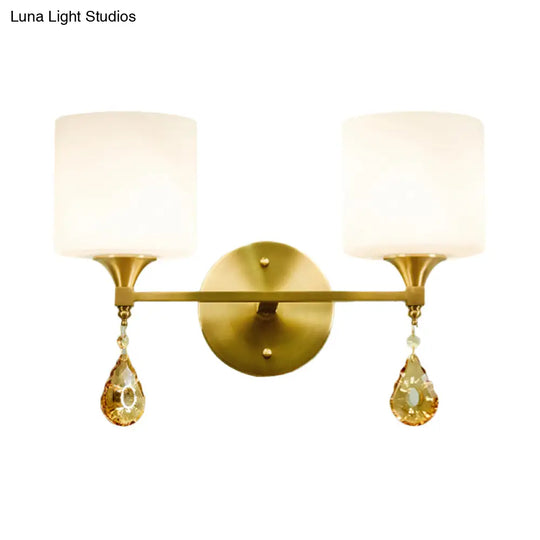 Modern Milk Glass Wall Sconce With Brass Finish And Amber Crystal Draping