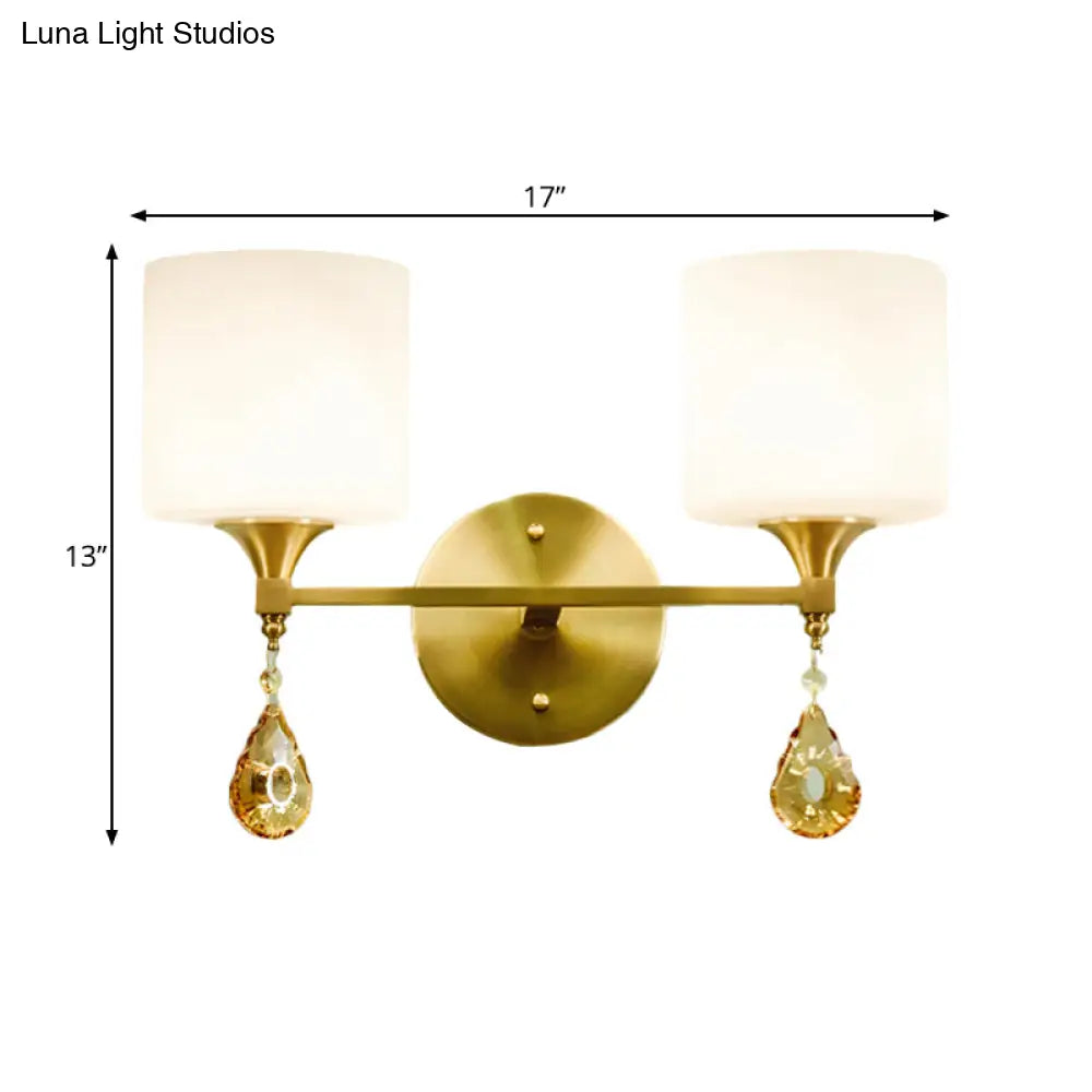 Modern Milk Glass Wall Sconce With Brass Finish And Amber Crystal Draping