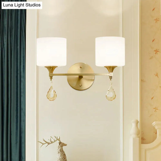 Modern Milk Glass Wall Sconce With Brass Finish And Amber Crystal Draping