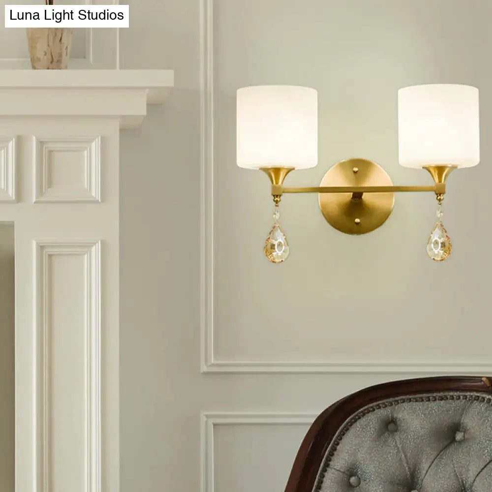 Modern Milk Glass Wall Sconce With Brass Finish And Amber Crystal Draping