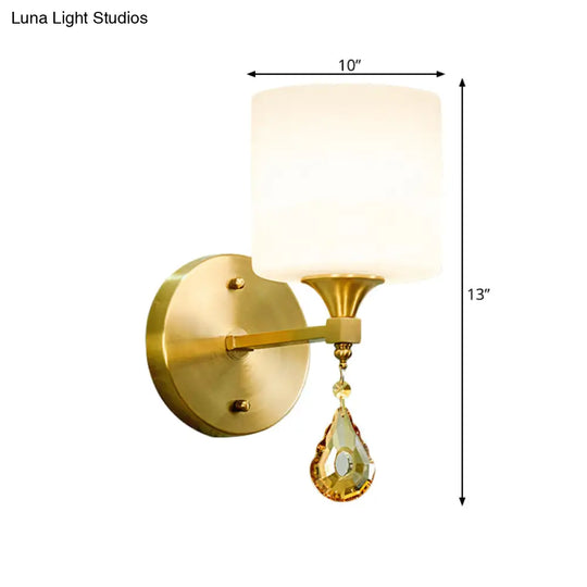 Modern Milk Glass Wall Sconce With Brass Finish And Amber Crystal Draping