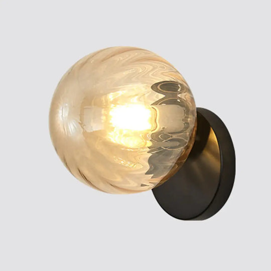 Modern Simplicity Wall Sconce: 1-Light Metal Lamp With Glass Ball Shade Black / Amber