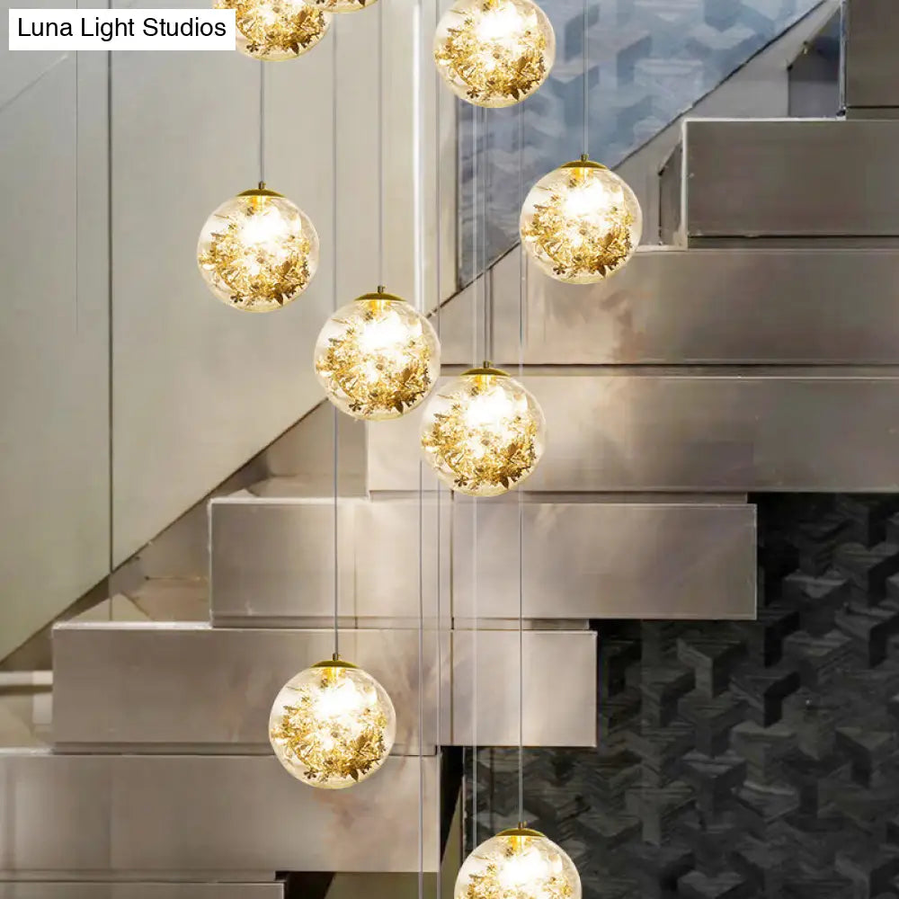 Minimalist Clear Glass Sphere Chandelier With Gold Metal Flower Decor - 10-Head Stairs Pendant Lamp