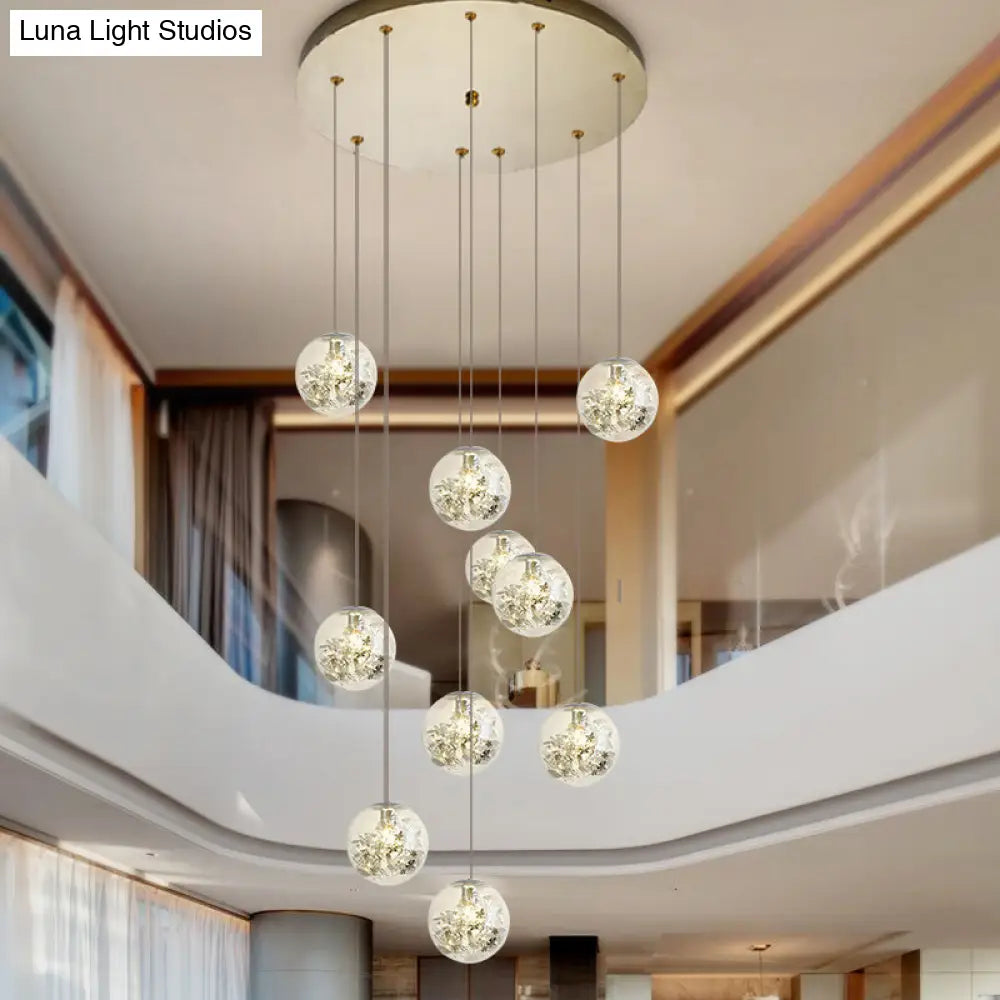 Minimalist Clear Glass Sphere Chandelier With Gold Metal Flower Decor - 10-Head Stairs Pendant Lamp