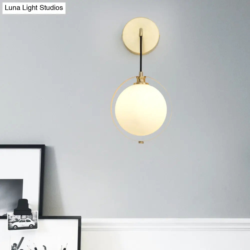 Modern White Glass Ball Sconce Light With Brass Wall Mount And Curved Arm - 1 Bulb