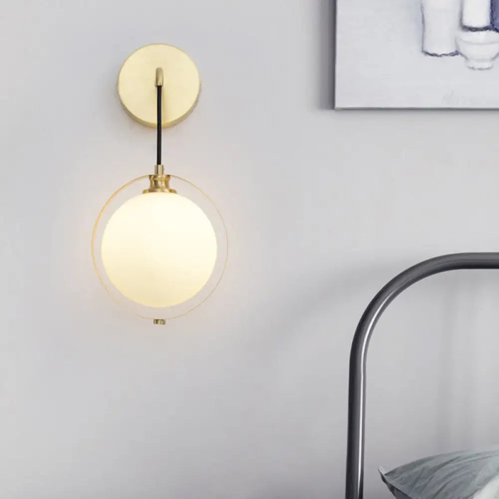 Modern White Glass Ball Sconce Light With Brass Wall Mount And Curved Arm - 1 Bulb