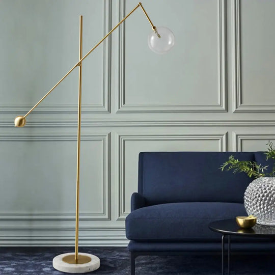 Modernist Gold Metal Balance Arm Task Floor Lamp With Orb Design Single Bulb Standing Light For