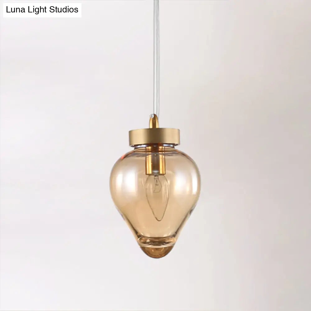 Modern Amber Glass Pendant With Gold Urn Design - Perfect For Dining Room Lighting