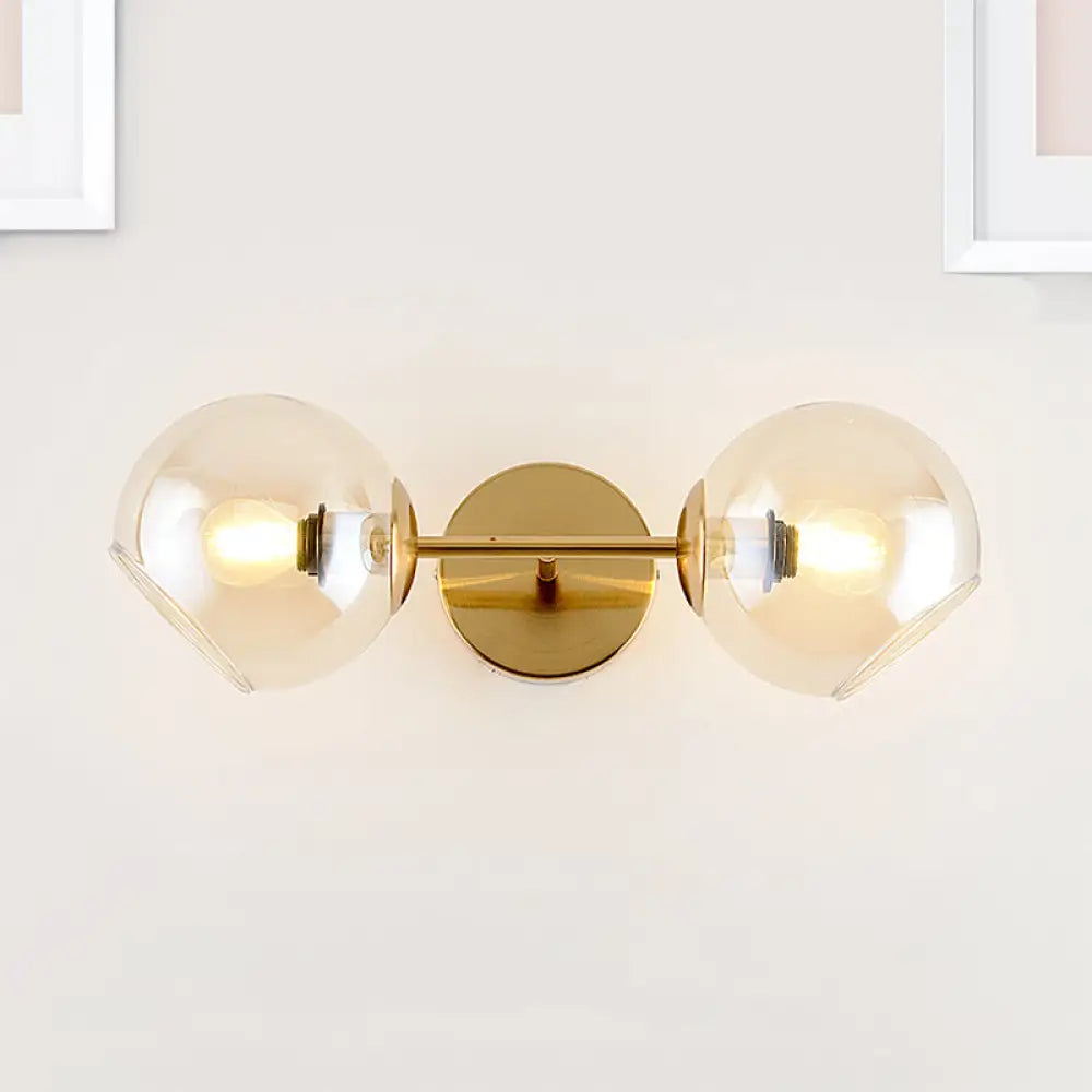 Modernist Gold Wall Lamp With Clear Glass Shade - 2 Lights Spherical Mount Fixture