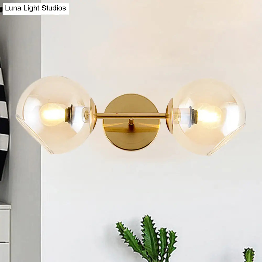 Modernist Gold Wall Lamp With Clear Glass Shade - 2 Lights Spherical Mount Fixture