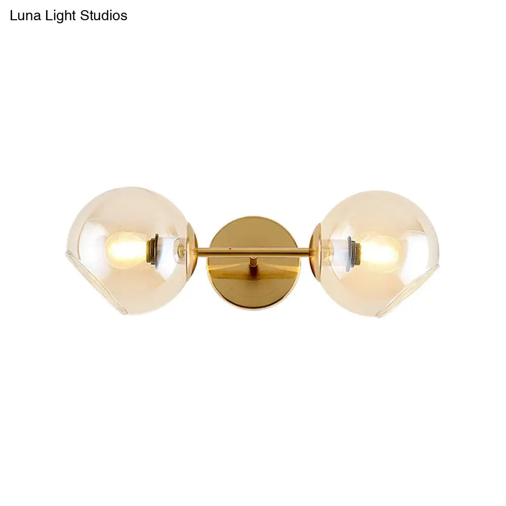 Modernist Gold Wall Lamp With Clear Glass Shade - 2 Lights Spherical Mount Fixture