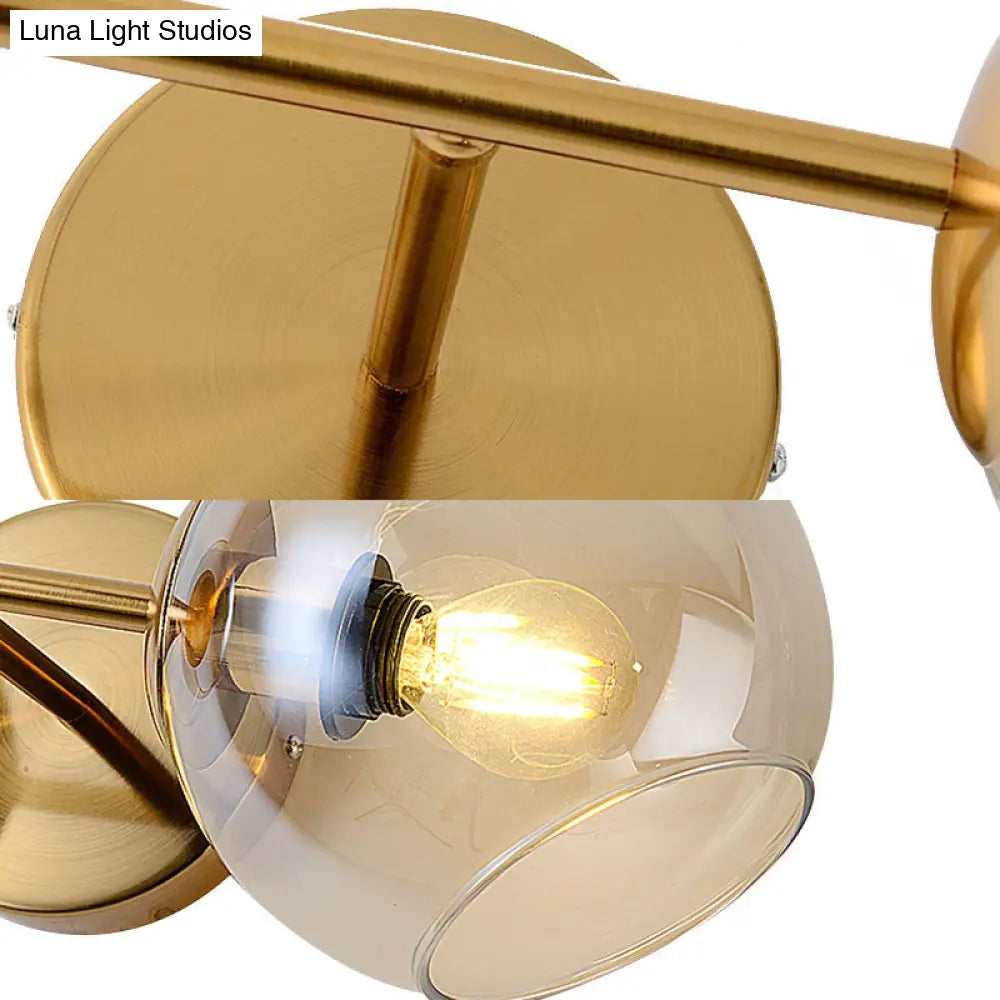 Modernist Gold Wall Lamp With Clear Glass Shade - 2 Lights Spherical Mount Fixture