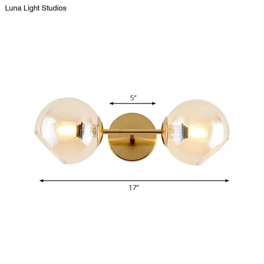 Modernist Gold Wall Lamp With Clear Glass Shade - 2 Lights Spherical Mount Fixture