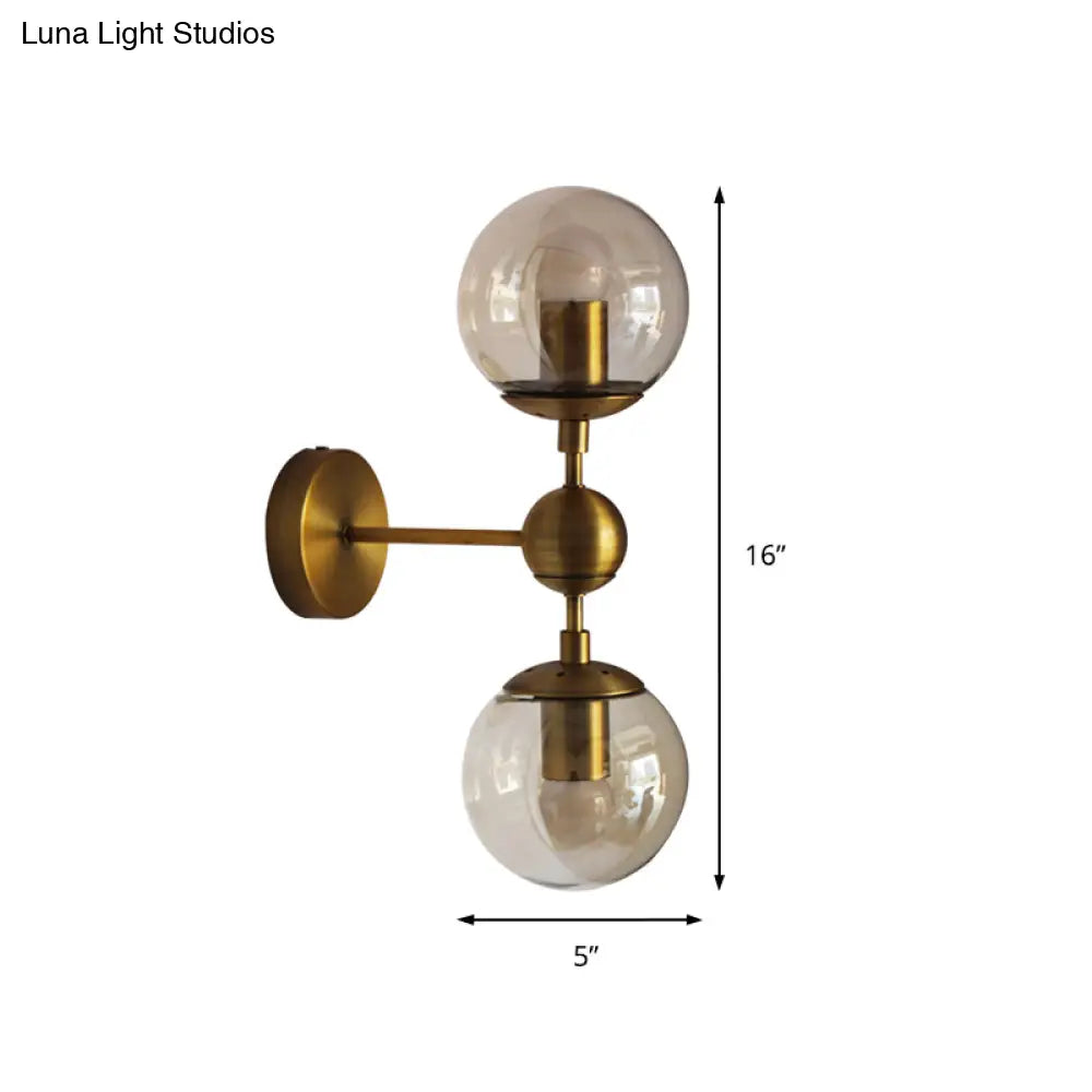 Post Modern Amber Glass Globe Wall Sconce With Brass Mount - 1/2 Light