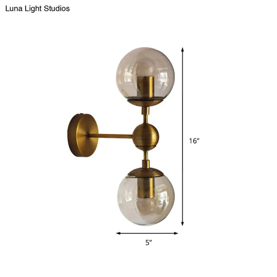 Post Modern Amber Glass Globe Wall Sconce With Brass Mount - 1/2 Light