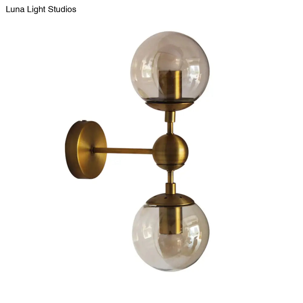 Post Modern Amber Glass Globe Wall Sconce With Brass Mount - 1/2 Light