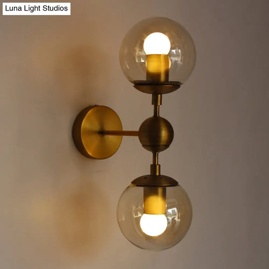 Post Modern Amber Glass Globe Wall Sconce With Brass Mount - 1/2 Light