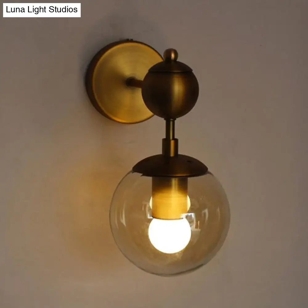 Post Modern Amber Glass Globe Wall Sconce With Brass Mount - 1/2 Light