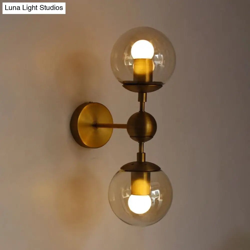 Post Modern Amber Glass Globe Wall Sconce With Brass Mount - 1/2 Light