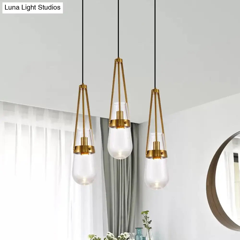 Clear/Blue Glass Pendant Lamp With Brass Gripper - Postmodern Drop Shape Dining Room Hanging Light