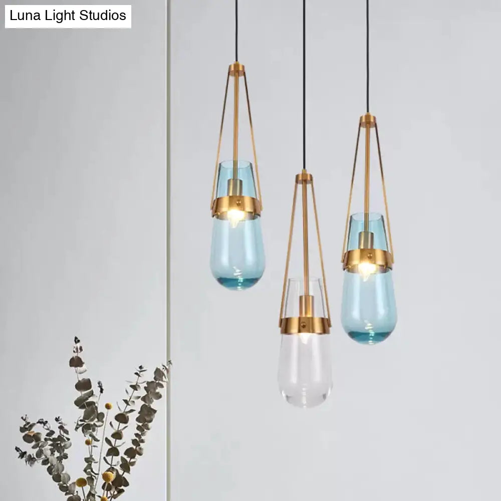 Clear/Blue Glass Pendant Lamp With Brass Gripper - Postmodern Drop Shape Dining Room Hanging Light