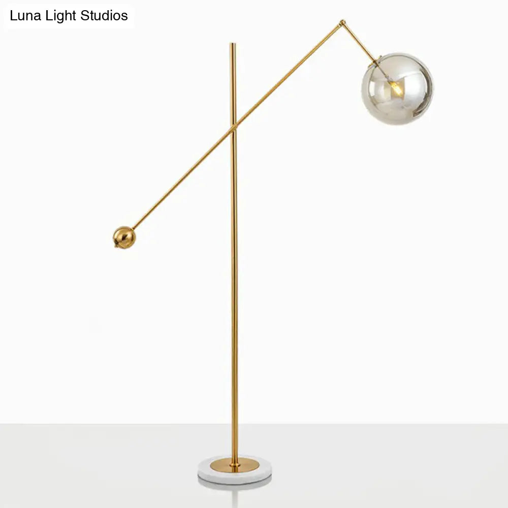 Postmodern Brass Plated Balance Arm Floor Lamp With Glass Spherical Shade - Stylish Metal Stand-Up