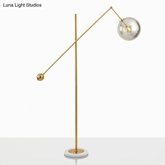 Postmodern Brass Plated Balance Arm Floor Lamp With Glass Spherical Shade - Stylish Metal Stand-Up